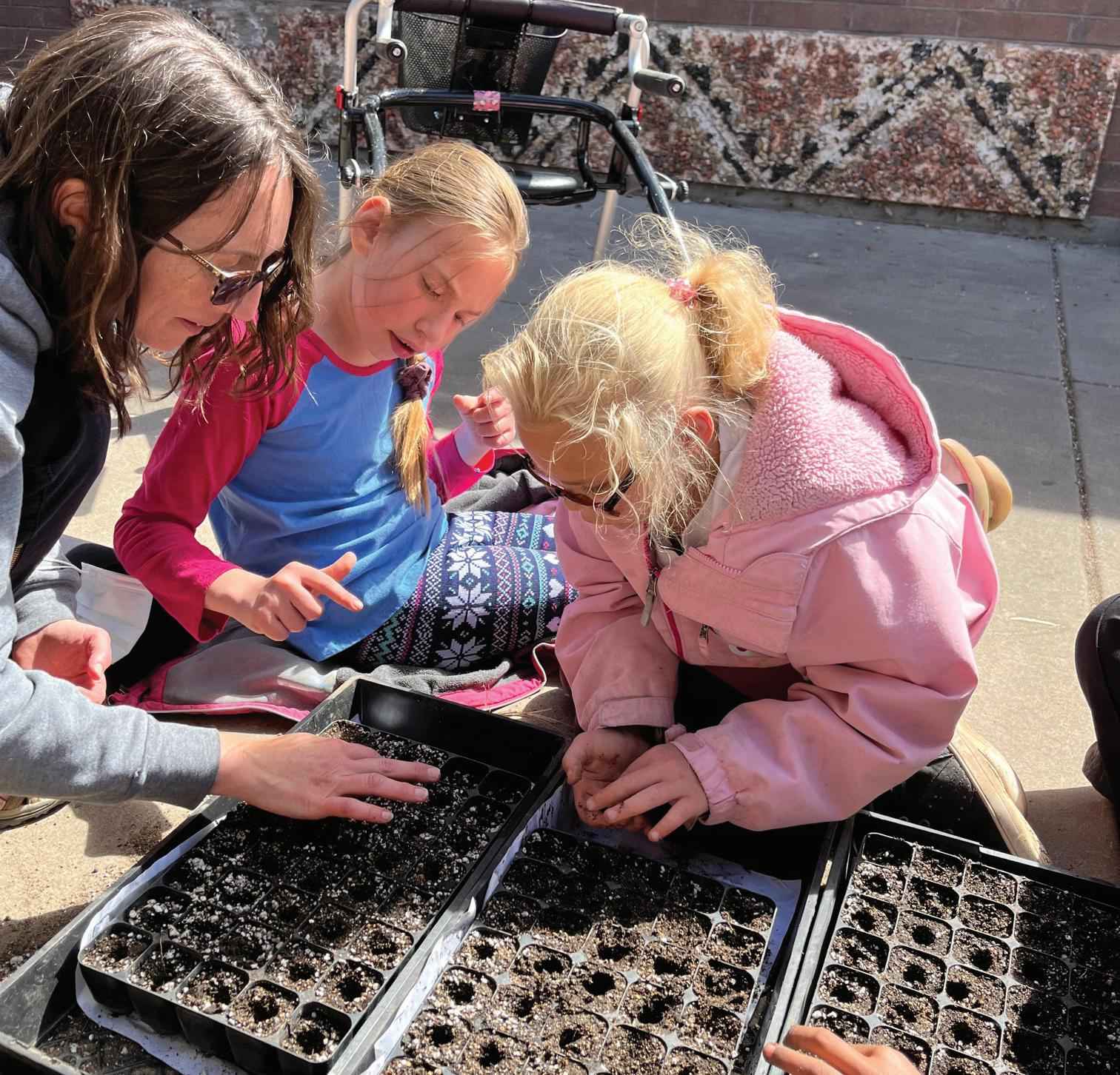 Kids check out seedlings with Land to Learn program.